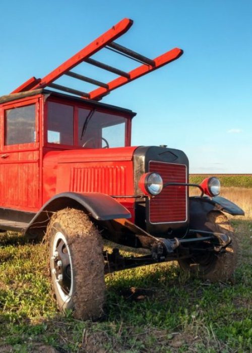 Old retro red fire truck with wooden case